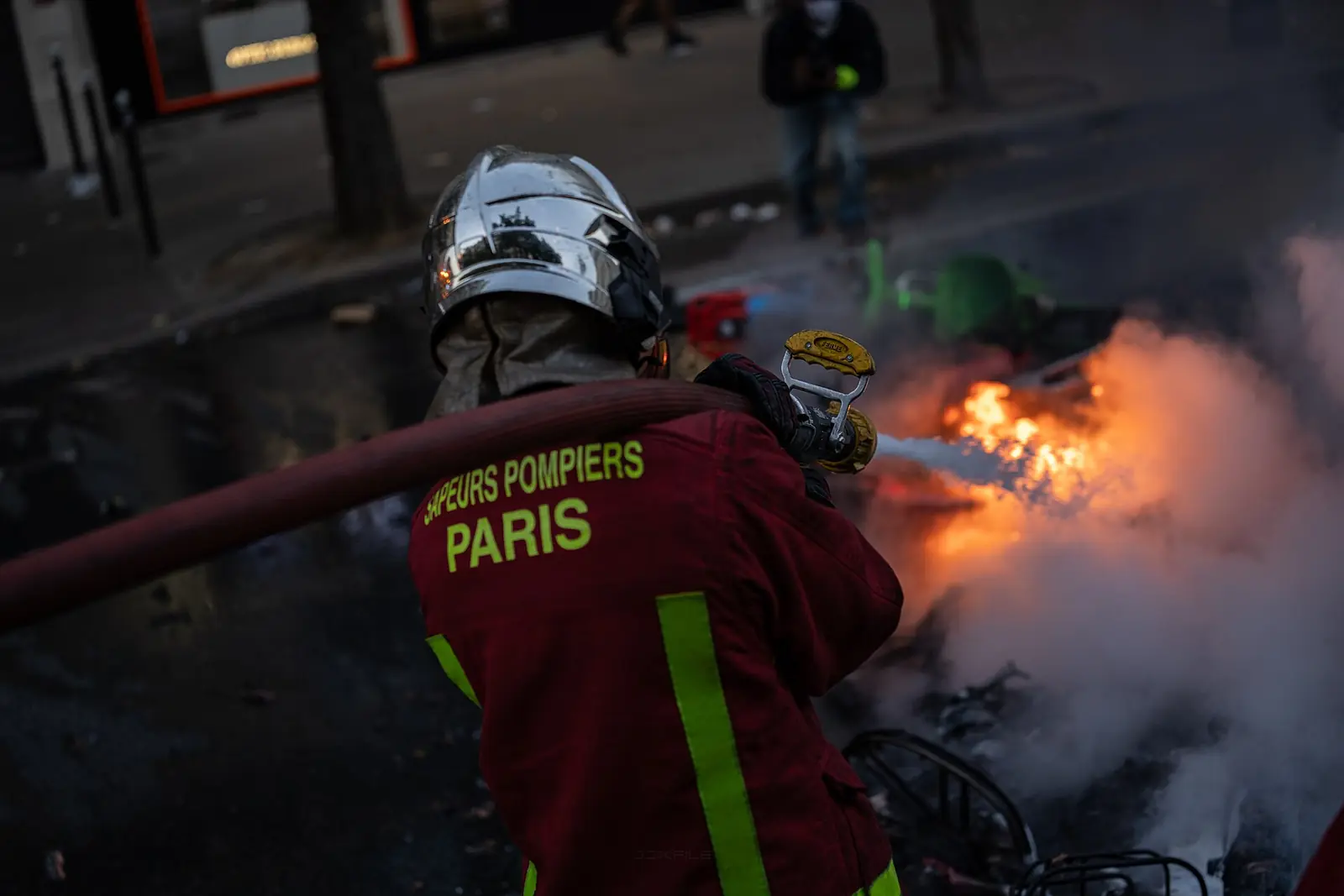 A Paris Fire Brigade firefighter puts out burning bicycles in Paris on 17 October 2026.