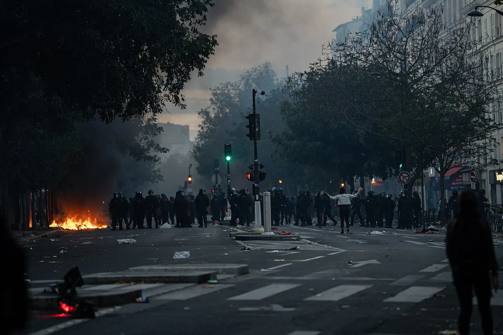 A police line and street fires in Paris on 17 October 2026.