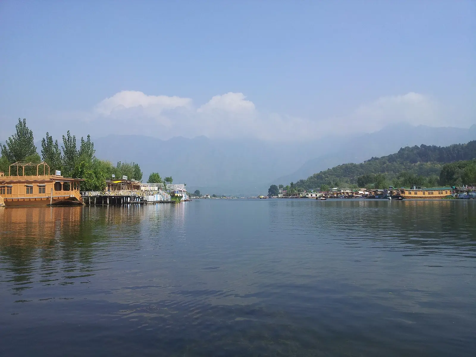 File photo, 2013: wooden houseboats along the shore of Dal Lake in Srinagar, with hills in the distance