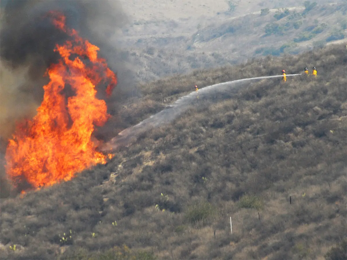 File photo: firefighters tackle a blaze during wildfires in Southern California, October 2007.